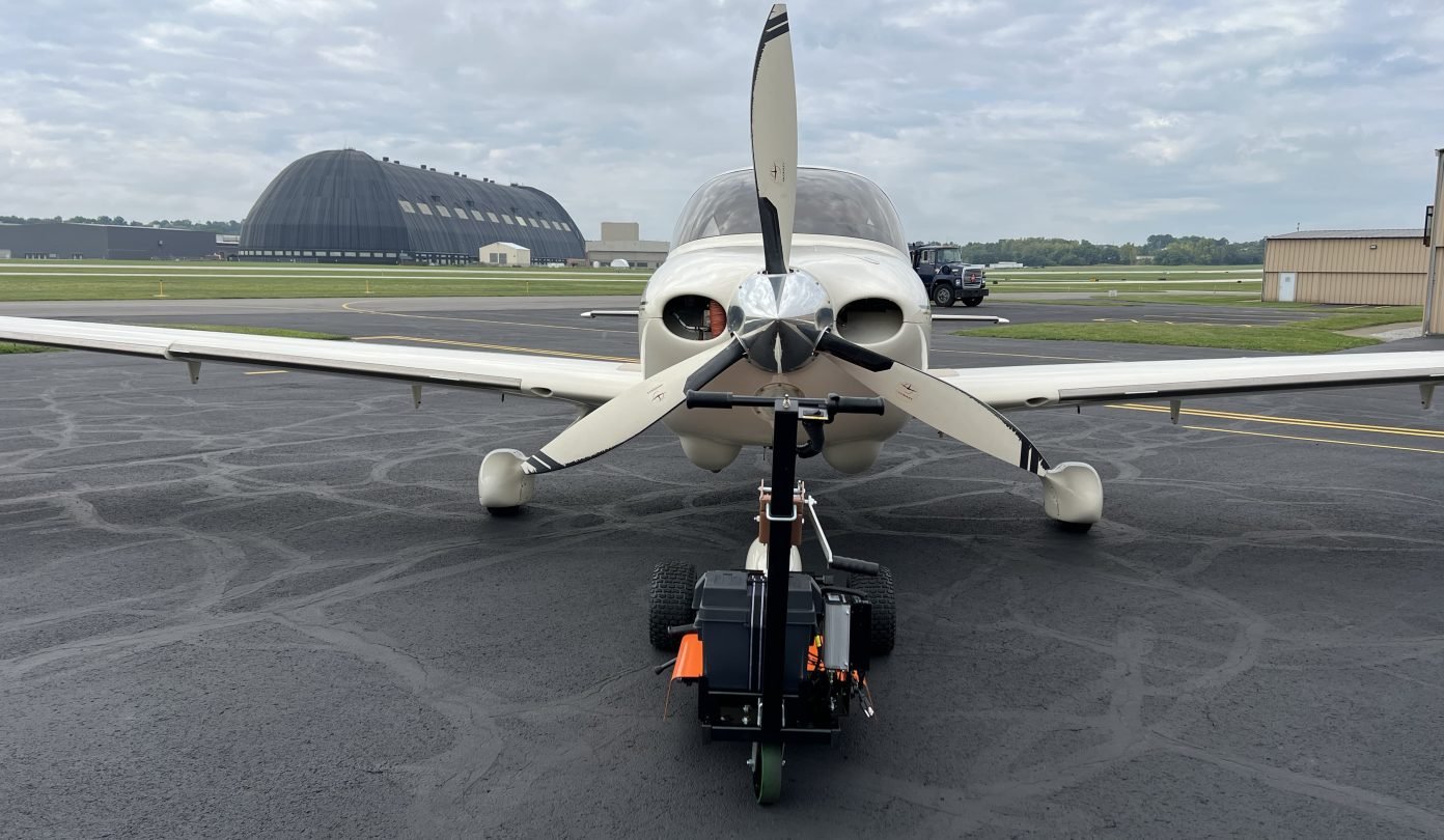 front view of a plane with aircraft tug attached