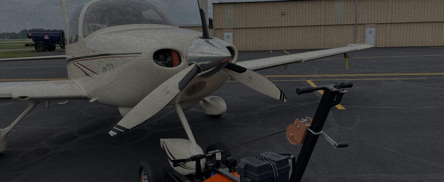 angled view of airtug aircraft tug pulling airplane